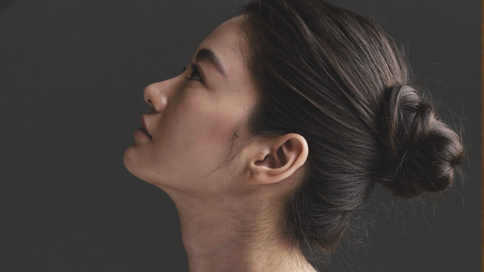 Dr Sin Yong assessing the submental area and jawline structure in clinic