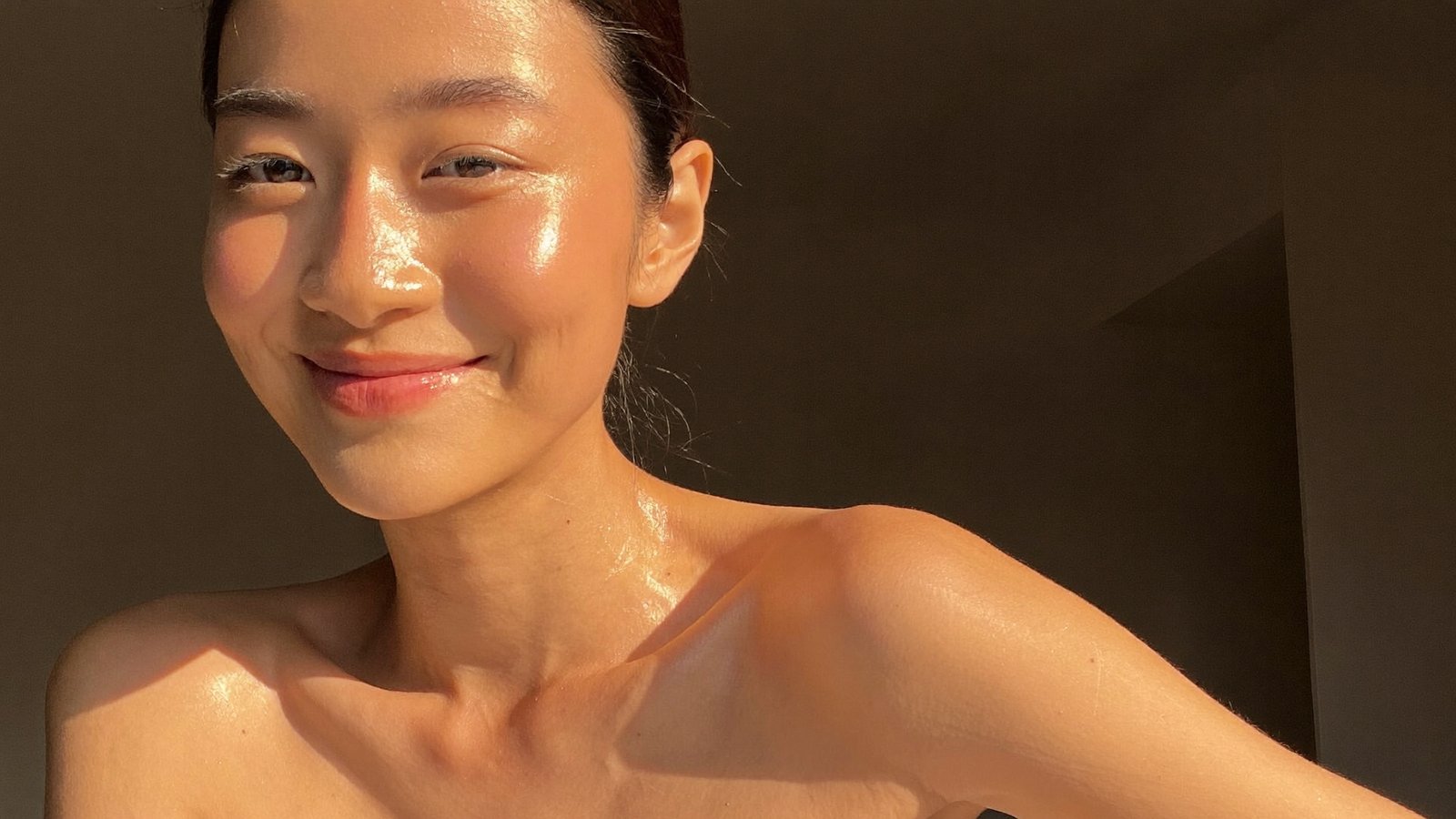 Dr Sin Yong examining skin surface texture and light reflection under clinical lighting