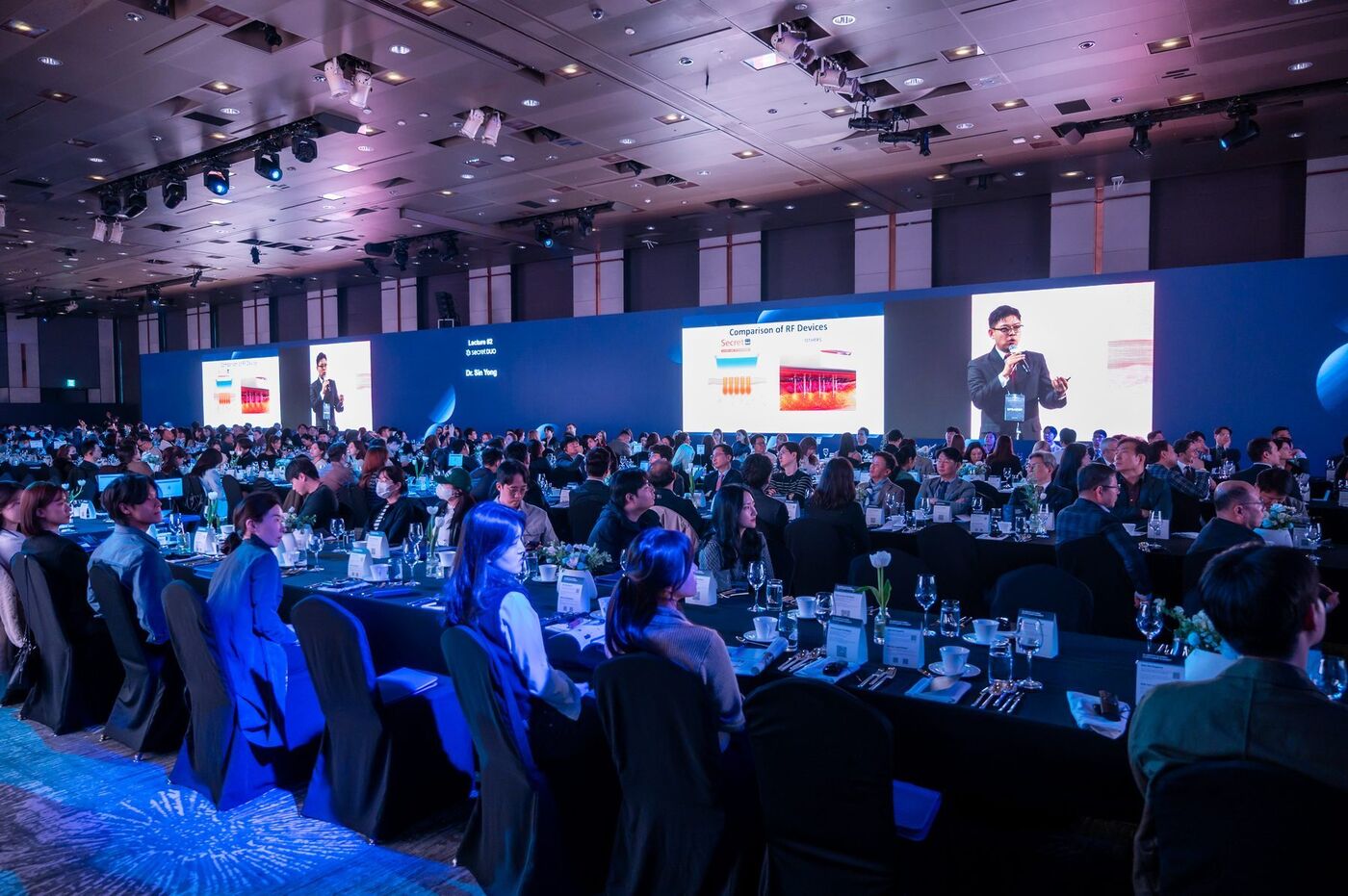 Dr Sin Yong lecturing on the main stage of the CLASSYS Global Customer Summit, Seoul 2025 — Comparison of RF Devices on screen