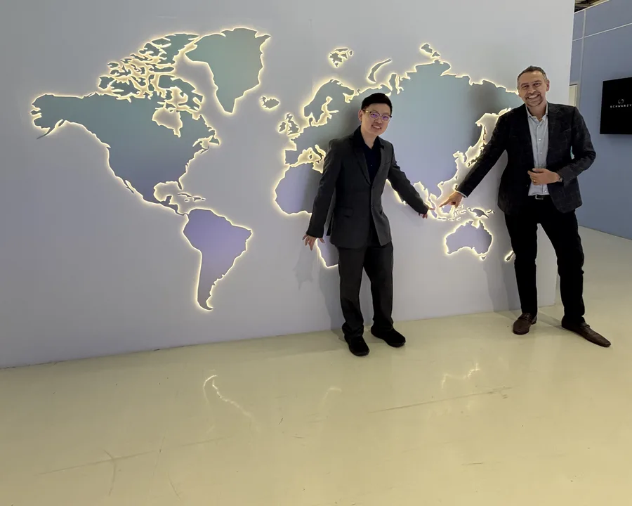Dr Sin Yong with Francesco Badii of the El.En. group at the DEKA world map wall, Florence