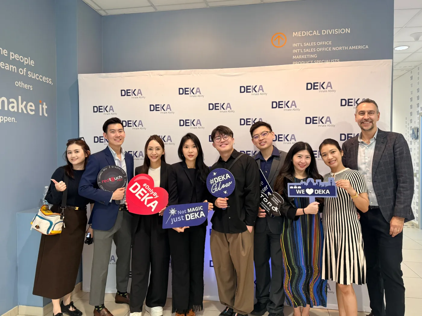 Dr Sin Yong with fellow physicians and the DEKA team at the DEKA backdrop in Calenzano