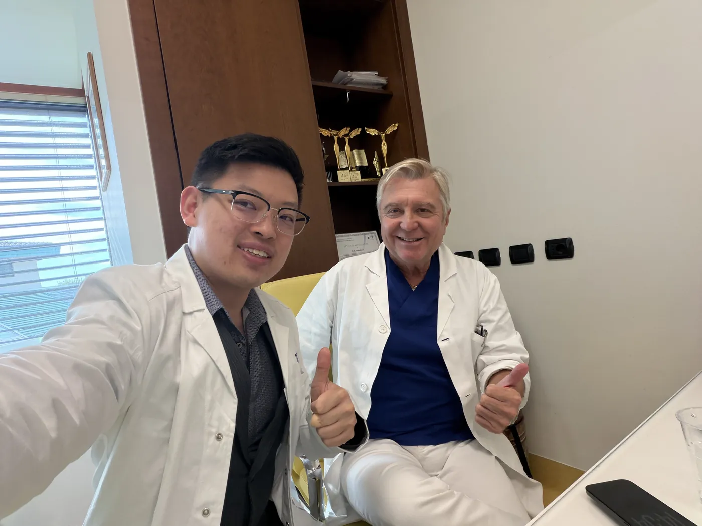 Dr Sin Yong with Prof Paolo Bonan, dermatologist and global DEKA speaker, in Prof Bonan's office in Florence