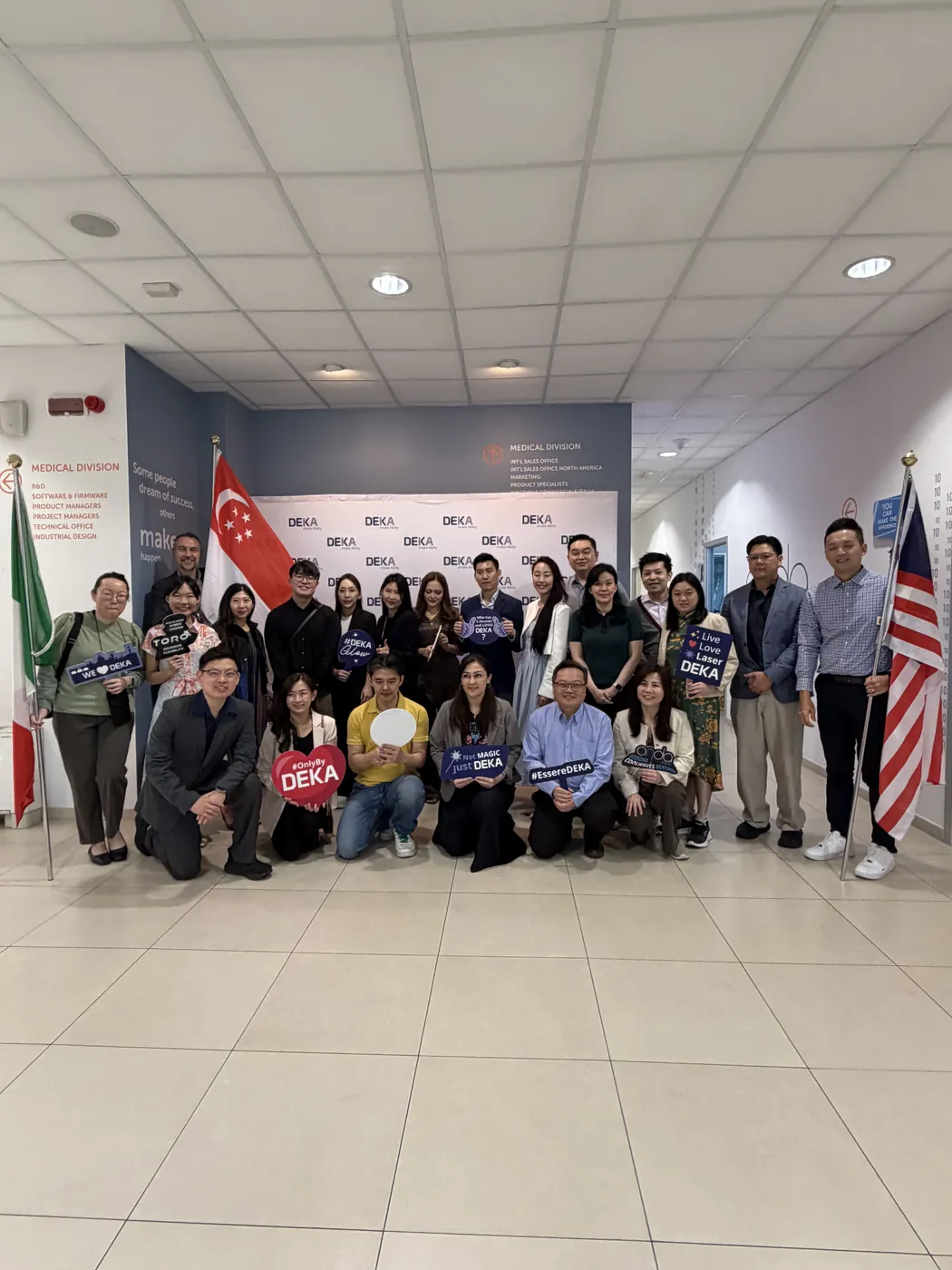 Physicians at the El.En. headquarters in front of the Italian, Singapore and other national flags