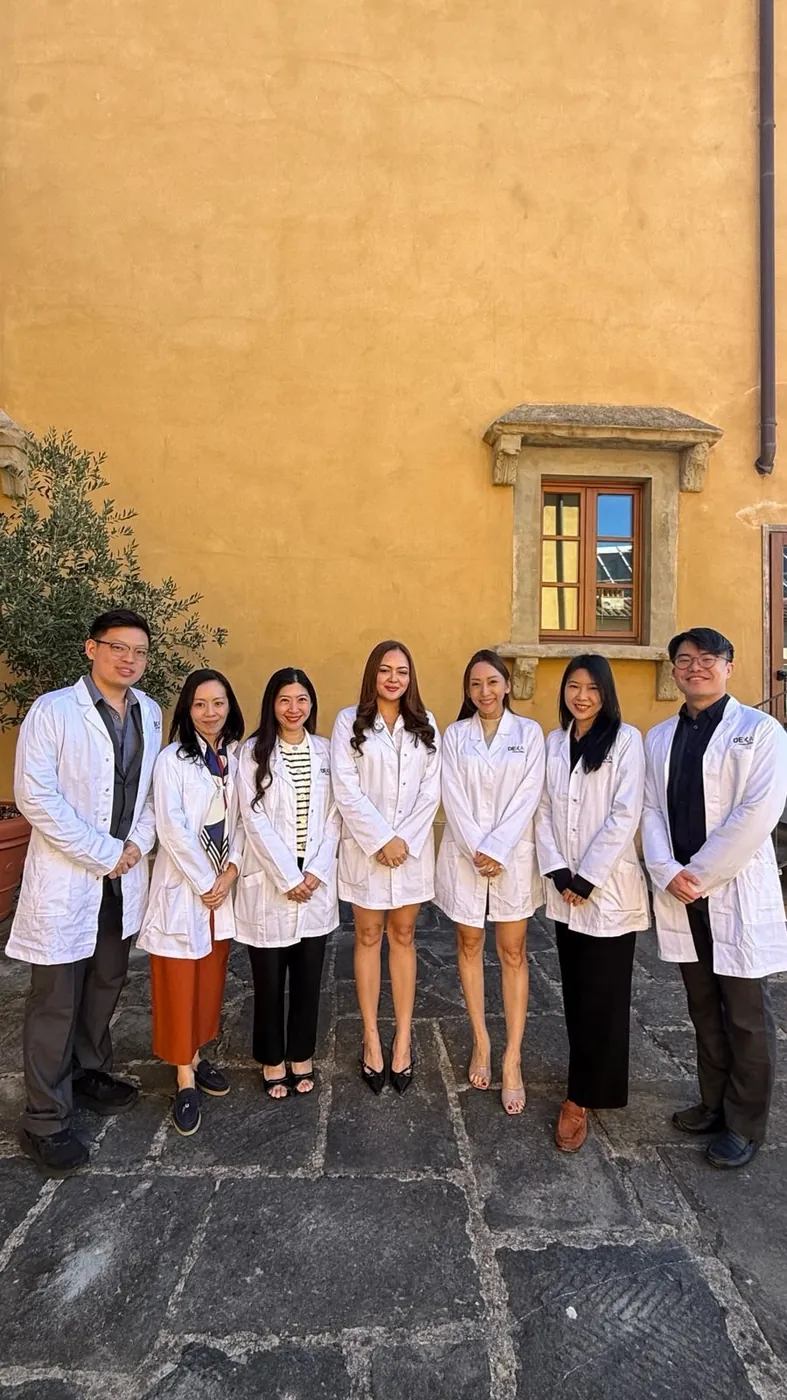 Dr Sin Yong with physicians in white coats in the Villa Donatello courtyard on day two