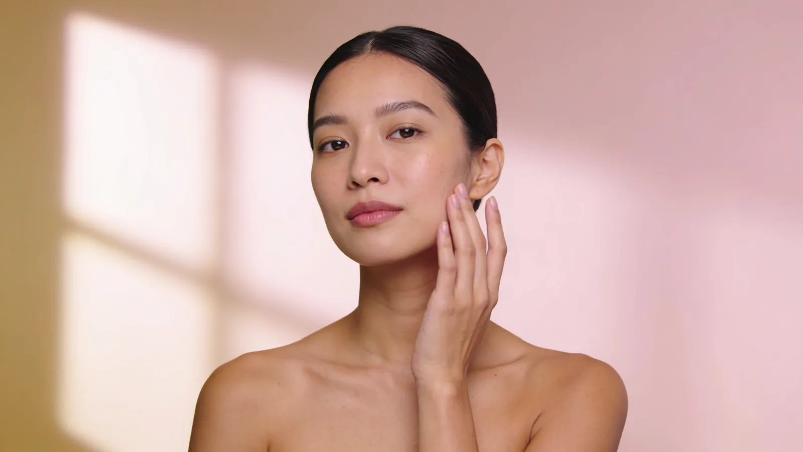 Illustrative image of a woman with calm, even skin, face fully in frame