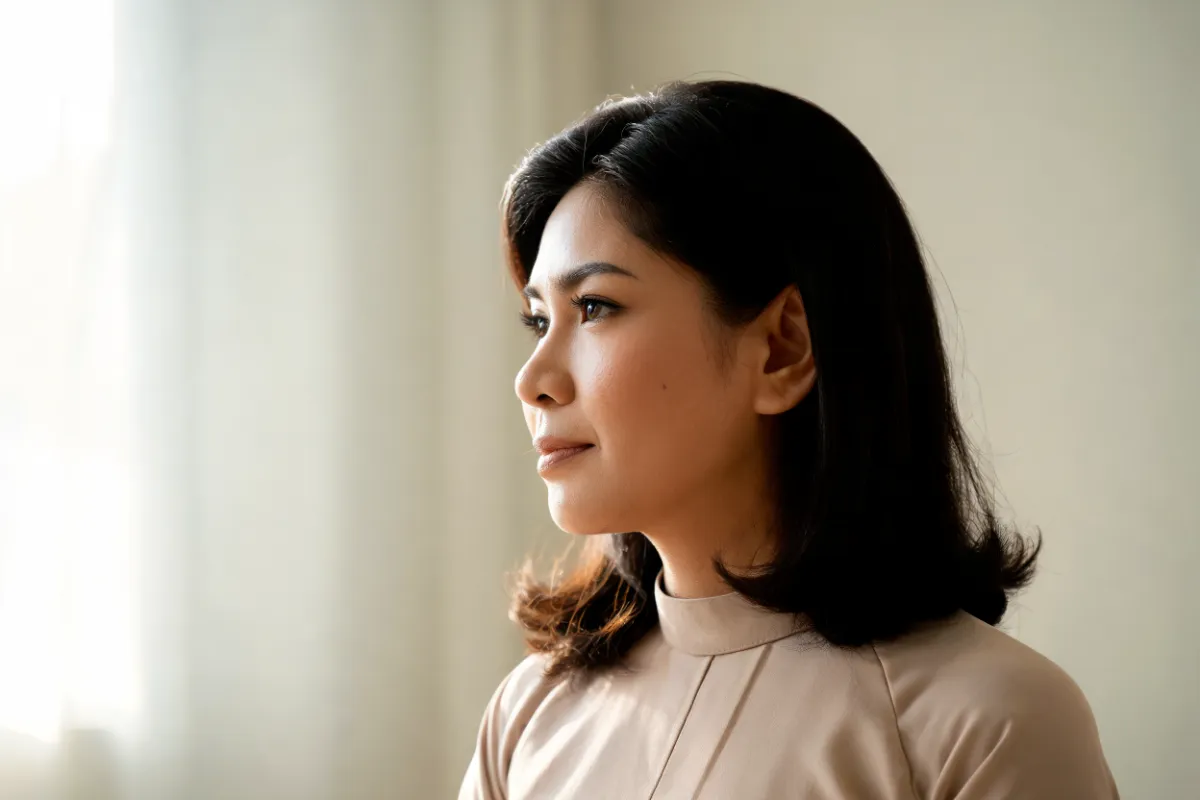 A woman in her thirties in soft profile light (illustrative image, not a patient)