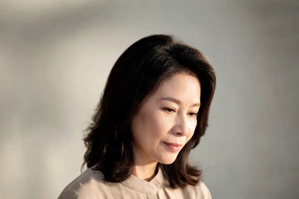 A woman in her forties with her jawline lit from the side (illustrative image, not a patient)