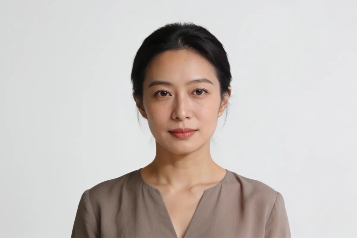 A woman in her thirties looking at the camera in soft frontal light (illustrative image, not a patient)