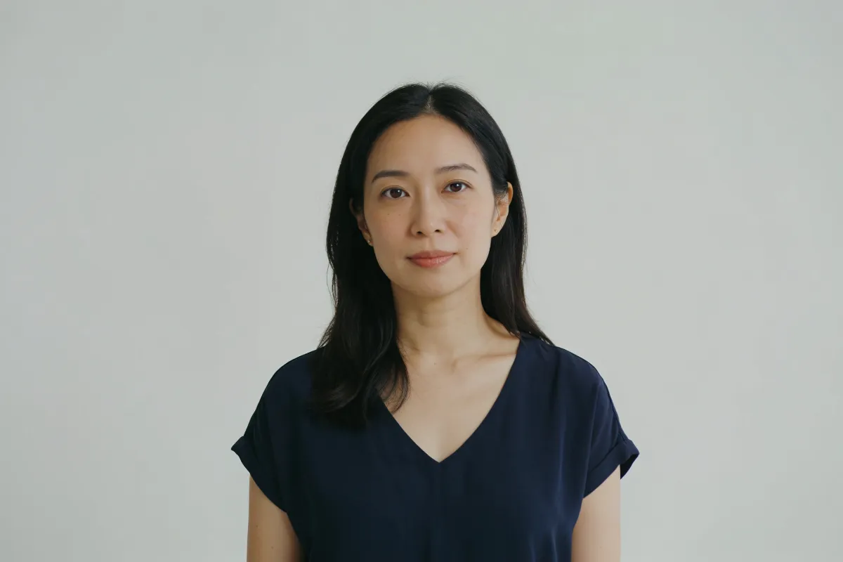A woman in her thirties looking at the camera in soft frontal light (illustrative image, not a patient)