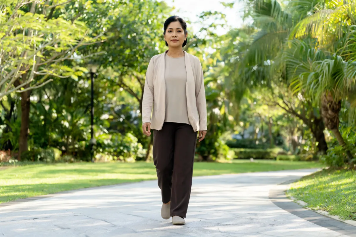 A woman in her forties walking in a park (illustrative image, not a patient)